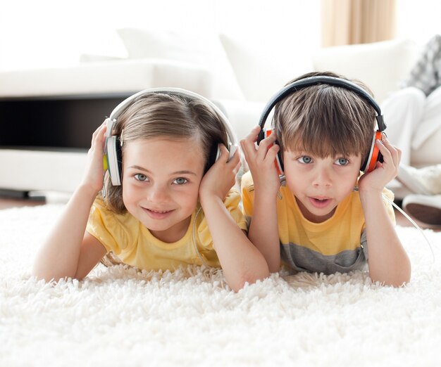 Close-up of children listening music with headphones 