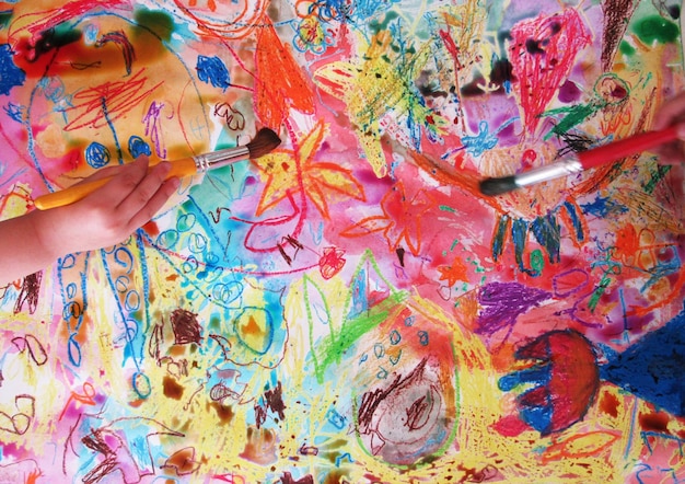 close-up of children painting a picture
