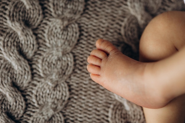 a close up of a childs foot with a crocheted pattern