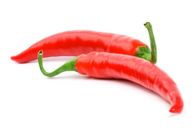 Close-up of chili peppers against white background