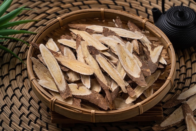 Close up of Chinese traditional herbal medicine Astragalus root on wooden table background.