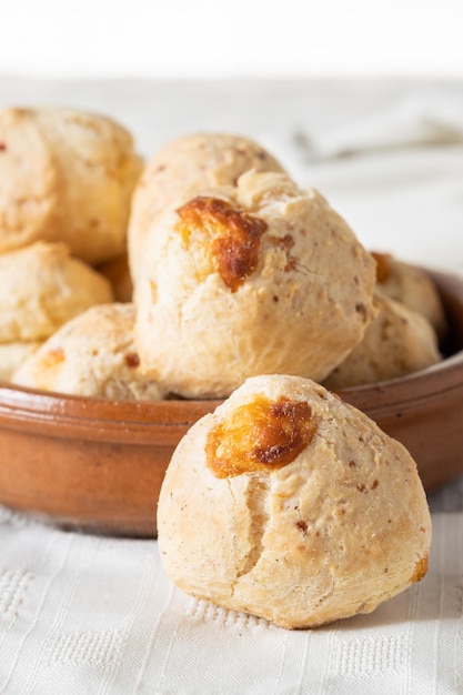 Close up of a chipa typical Paraguayan cheese bread on white table cloth