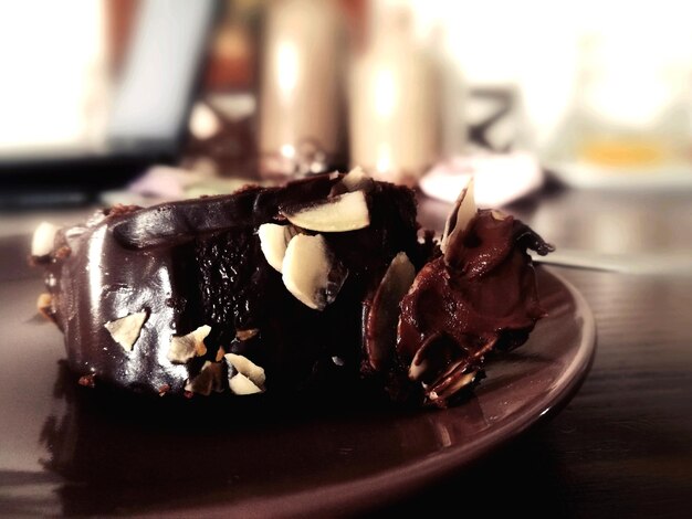 Photo close-up of chocolate cake in plate on table