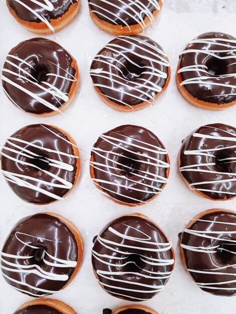 Photo close-up of chocolate donut on white table