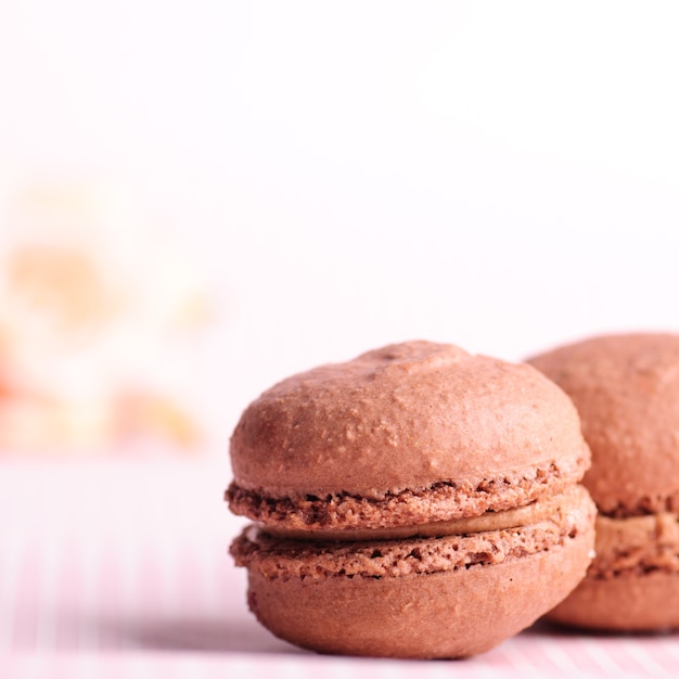 Close up chocolate macaroons on table