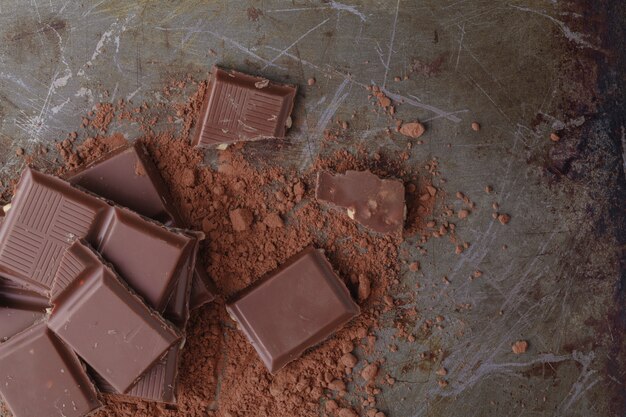 Close up of chocolate pieces on wooden background