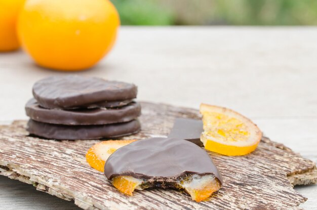 Close-up of chocolates with oranges on table