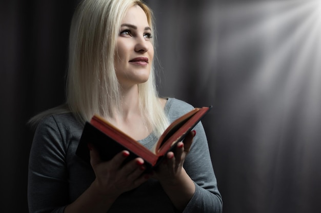 A close-up of a christian woman reading the bible.