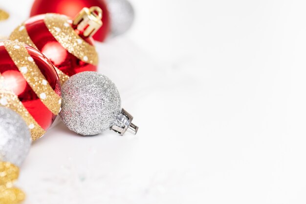 Close up Christmas balls with red ribbon and snowflake on abstract background