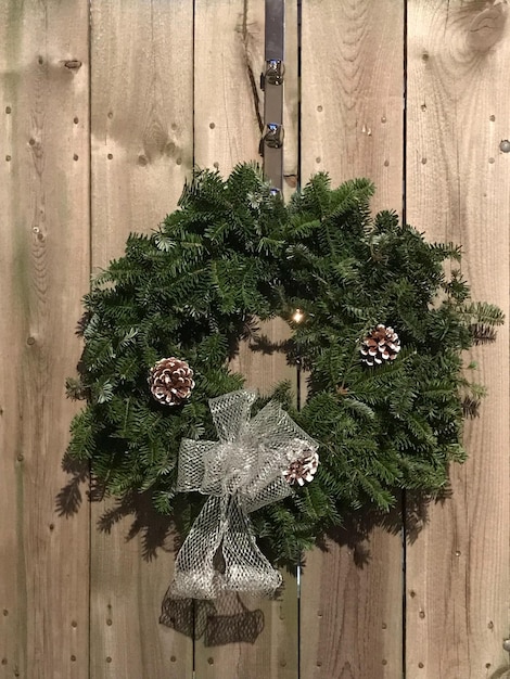 Close-up of christmas decoration hanging on wooden wall