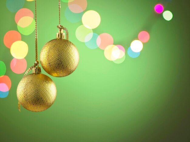 Close-up of christmas decorations and defocused illuminated lights against green background