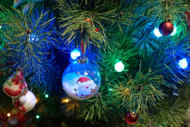 Close up of Christmas decorations hanging on tree. Decorated Christmas tree background. Merry Christmas and Happy New Year.