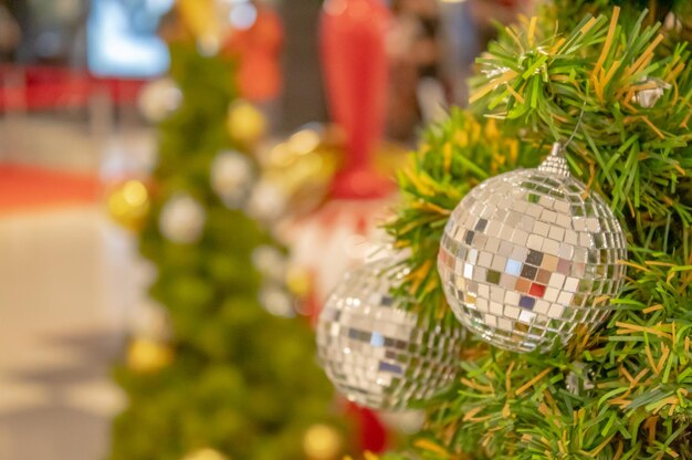 Close-up of christmas decorations hanging on tree at night