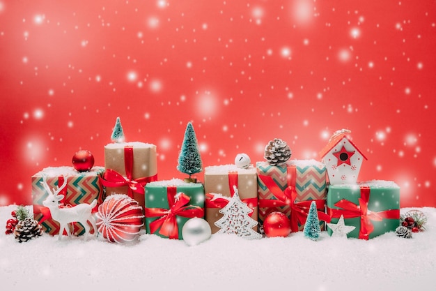 Close-up of christmas decorations and presents against red background