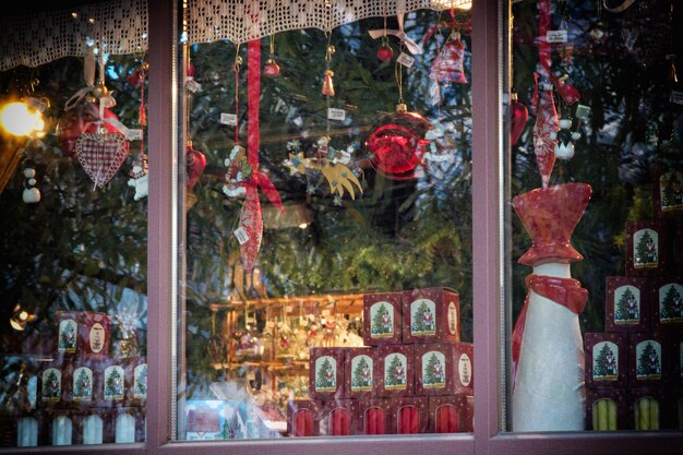 Photo close-up of christmas decorations for sale in store seen through window