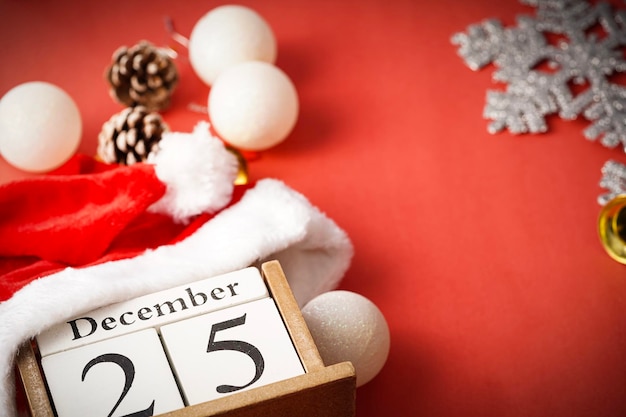 close-up of christmas decorations with calendar date on red background