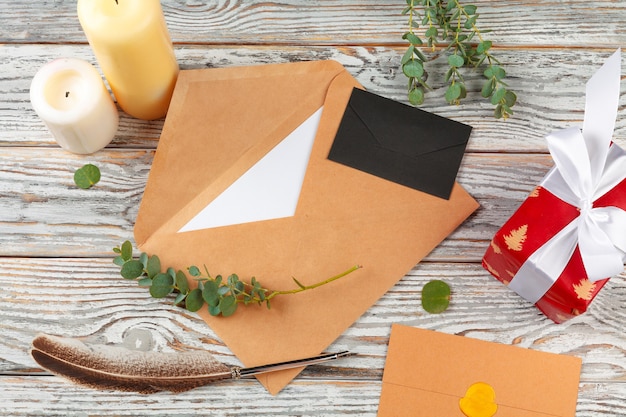 Close up of christmas letter writing on yellow paper on wooden background with decorations
