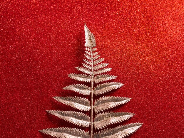 Photo close-up of christmas tree against red background