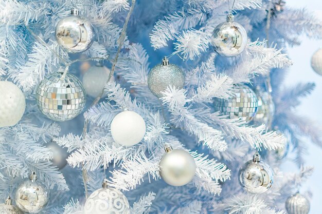 Close up of Christmas tree with white ornaments still life