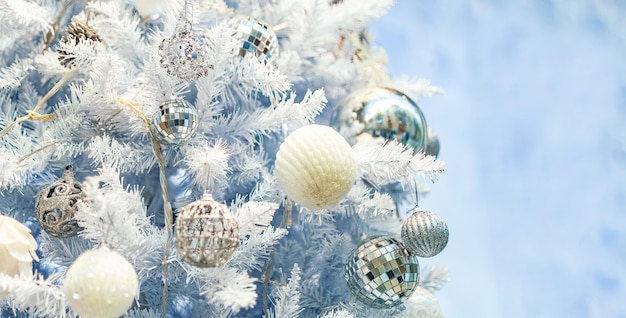 Close up of Christmas tree with white ornaments still life