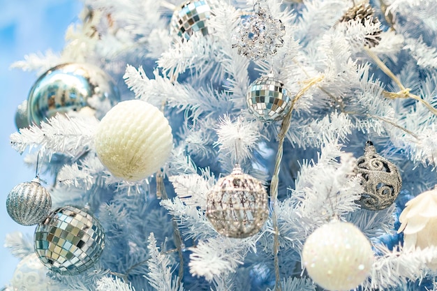 Close up of christmas tree with white ornaments still life