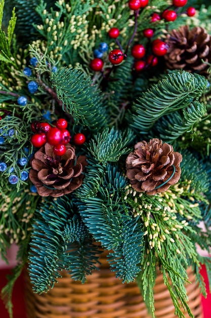 Close up of Christmas wreath decorated with pinecones and berries.