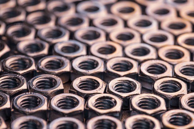 Close-up chrome metal nuts in the form of honeycombs