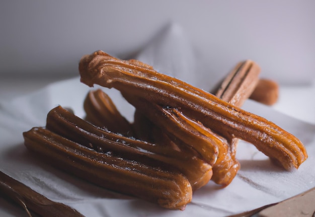 Close up of churros on white background created using generative ai technology