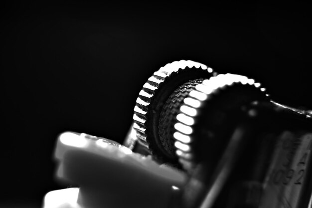 Photo close-up of cigarette lighter against black background