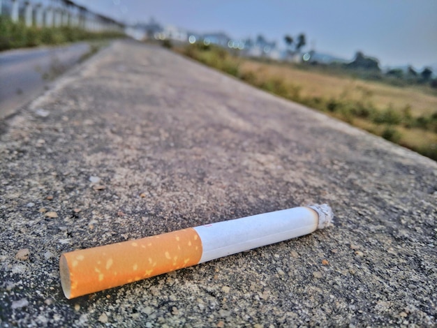 Close-up of cigarette on road