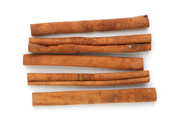 Close up cinnamon sticks isolated on white surface