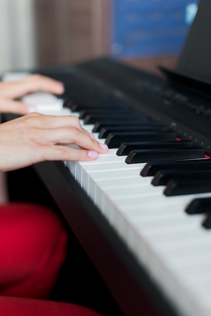 Close-up of a classic music performer's hand playing the piano or electronic synthesizer in music school