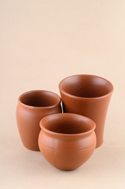 Close-up of Clay pots on cream color background