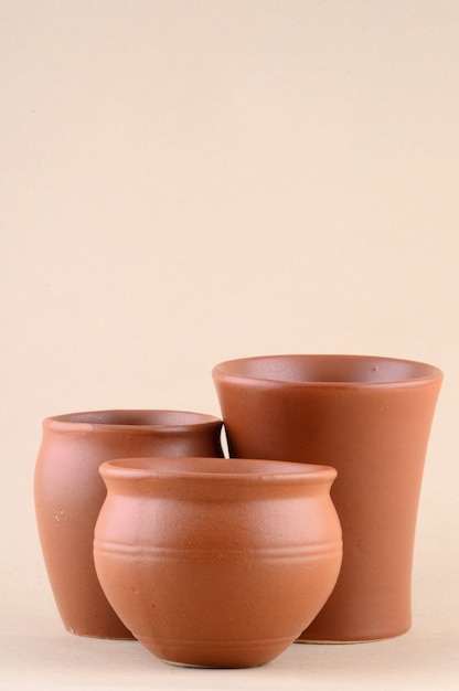 Close-up of clay pots on cream color wall