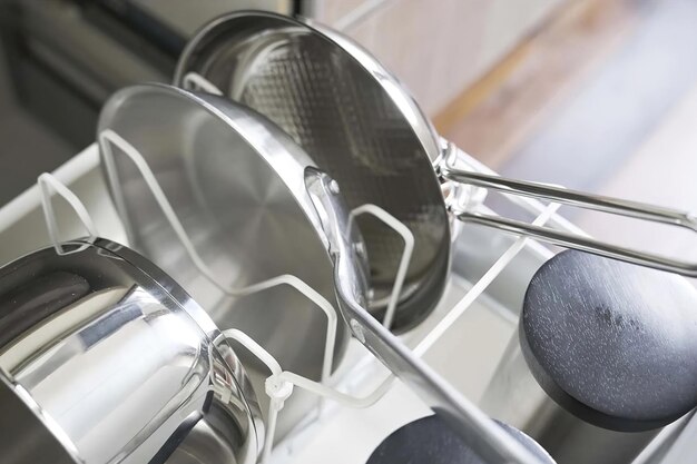 Close up of clean pans in open drawer