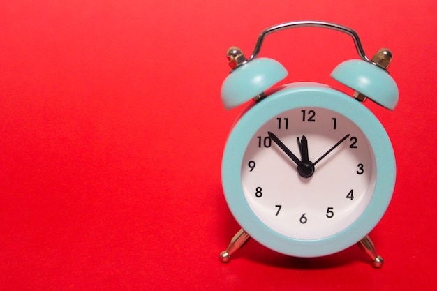 Close-up of clock against red background