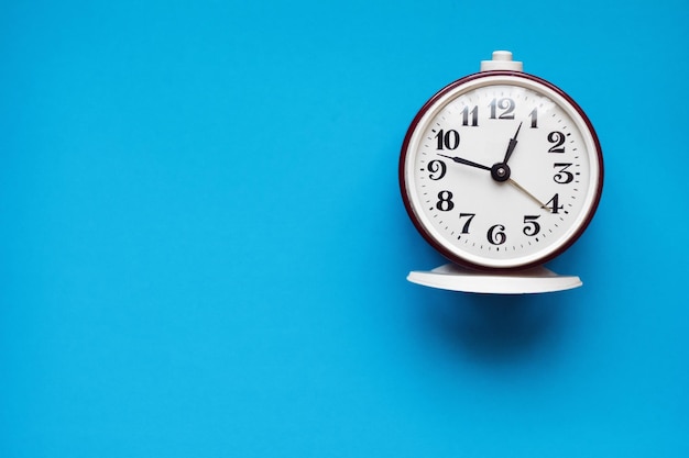 Close-up of clock over blue background