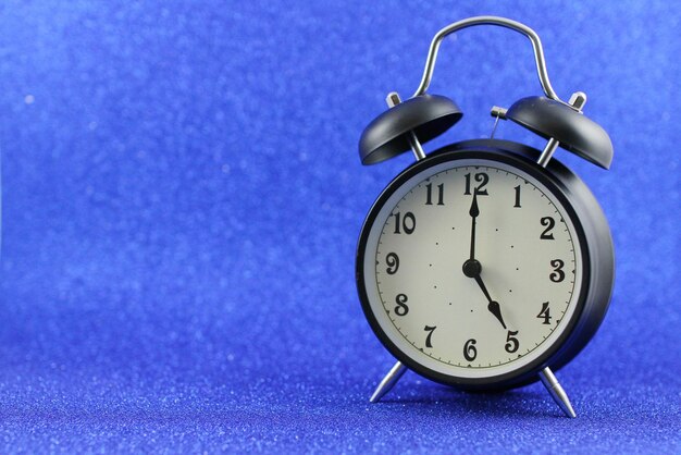 Close-up of clock on purple table