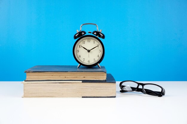 Close-up of clock on table against blue background