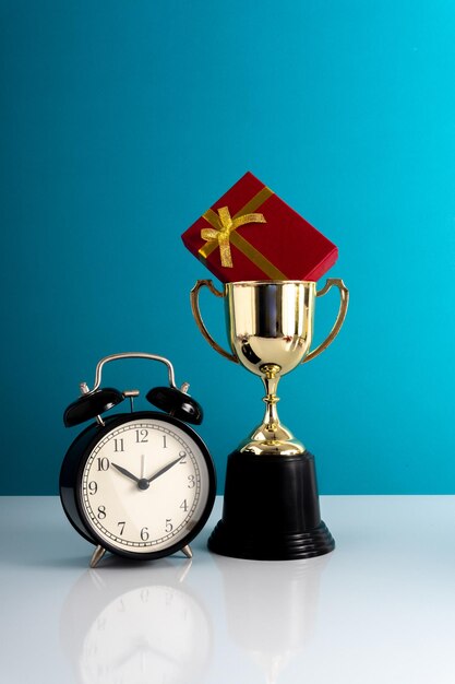 Close-up of clock on table against blue background