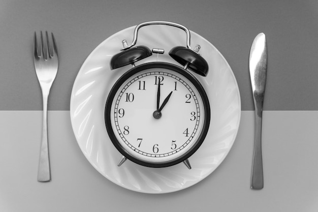 Close-up of clock on table against wall