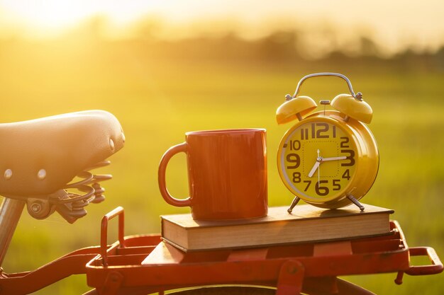 Close-up of clock on table at sunset