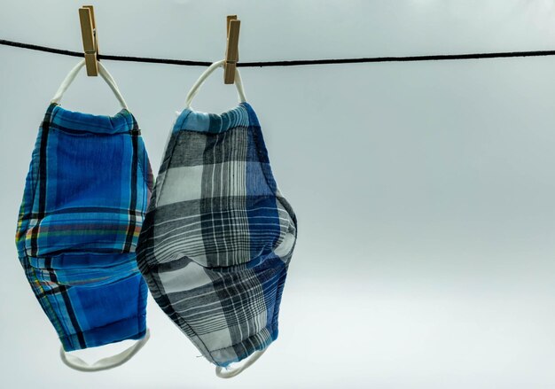 Close-up of clothes drying against blue background