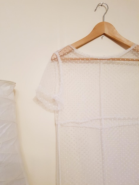 Photo close-up of clothes hanging against white wall