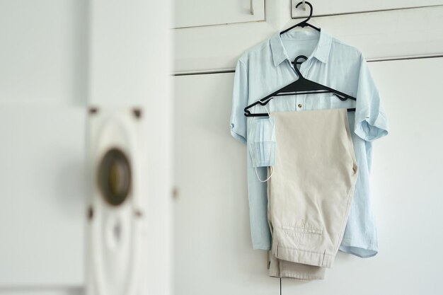 Photo close-up of clothes hanging against white wall