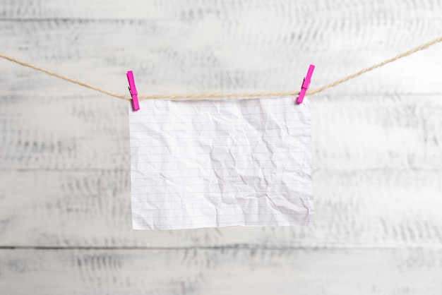 Photo close-up of clothes hanging on clothesline against white background