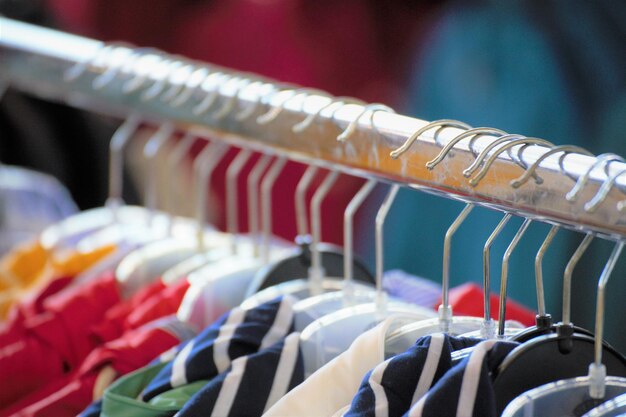 Close-up of clothes hanging on rack in store