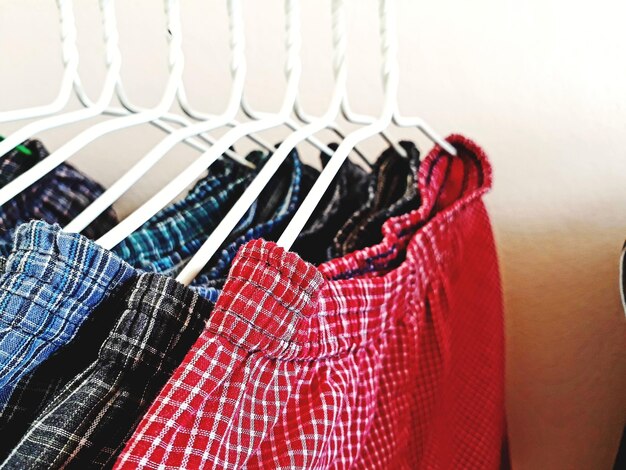 Photo close-up of clothes hanging on rack