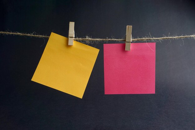 Photo close-up of clothes hanging on rope against colored background