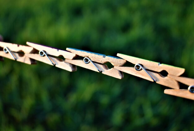 Close-up of clothespins hanging on clothesline